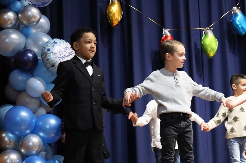 Students singing on stage.