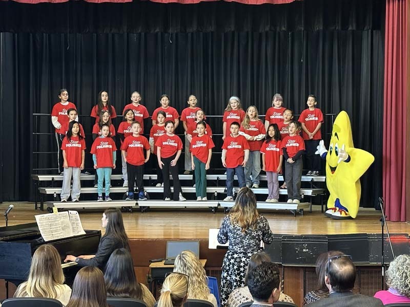 Students performing on stage.