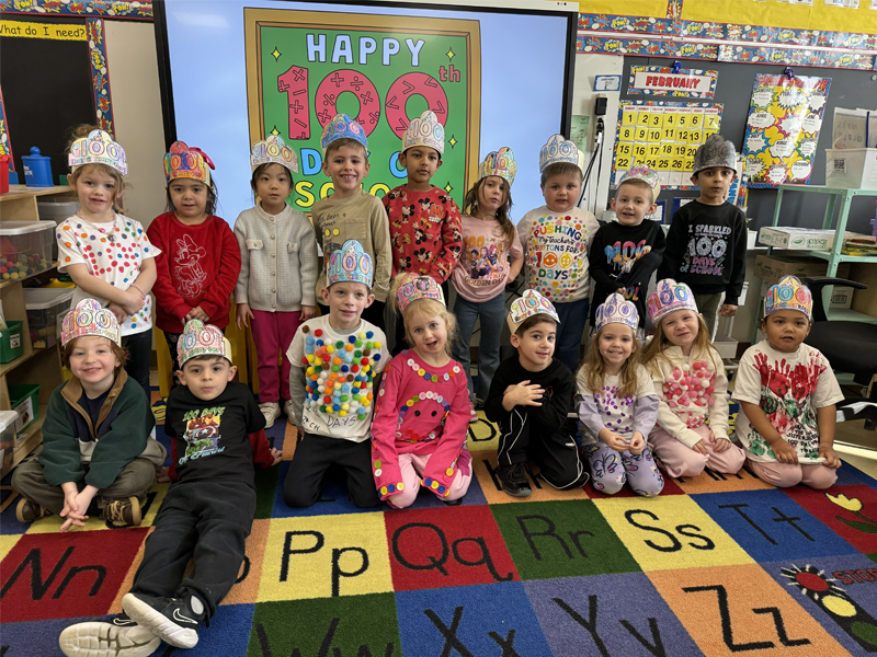 Students sitting on carpet.