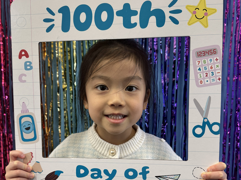 Student smiling for 100th day of school.