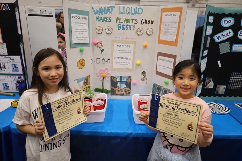 Students proudly showing off their projects.