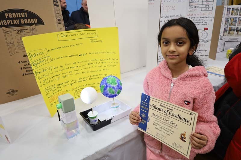 Students proudly showing off their projects.