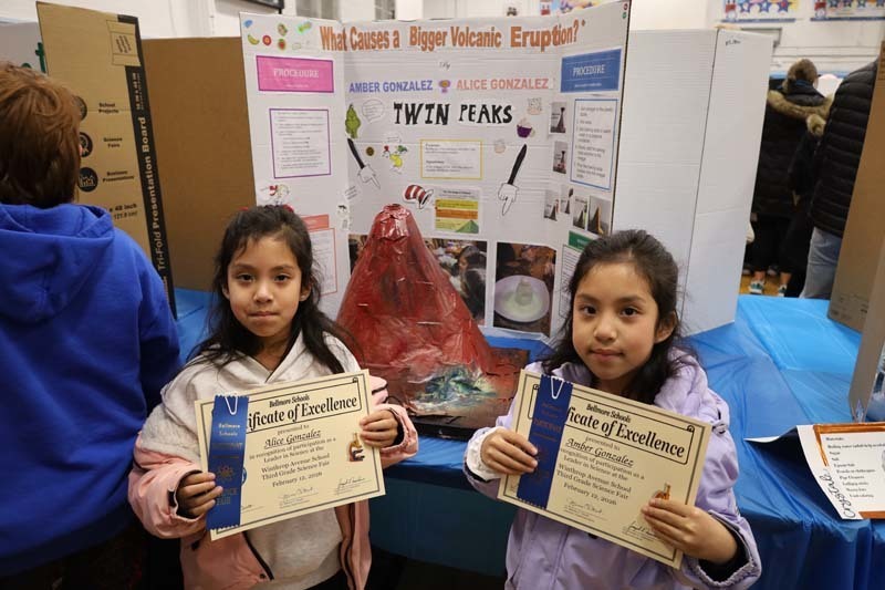 Students proudly showing off their projects.