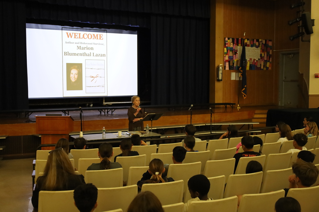 Woman giving presentation to audience.