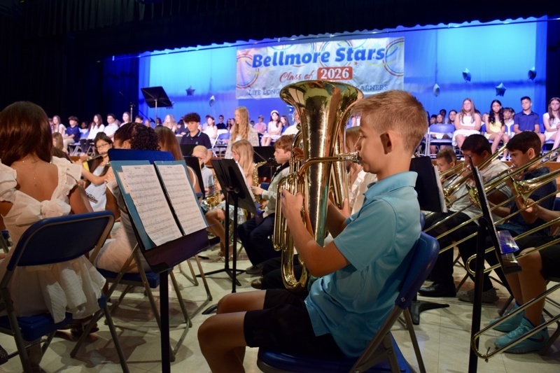 young musician playing tuba on stage