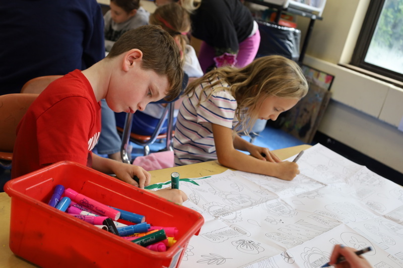 Students coloring at a table