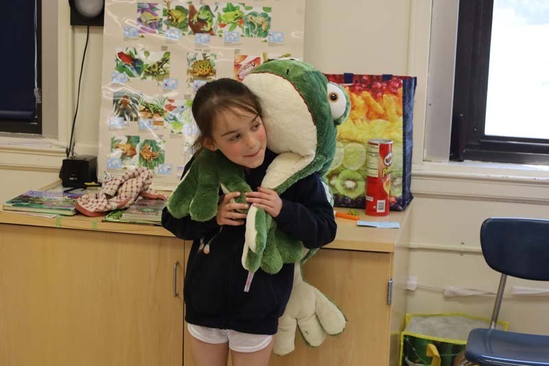 Student with stuffed frog.