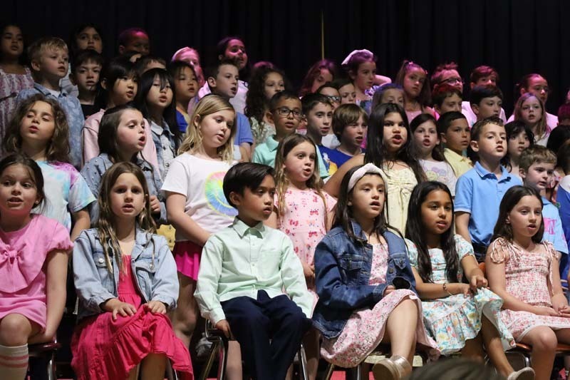 Students performing on stage.