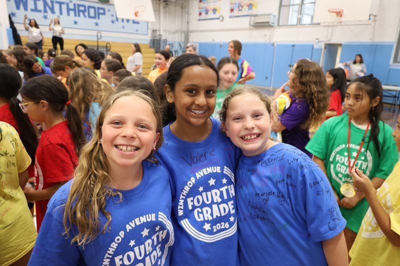 Students smiling in gymnasium.