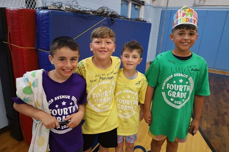 Students smiling in gymnasium.