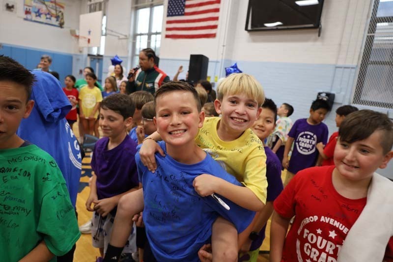 Students smiling in gymnasium.