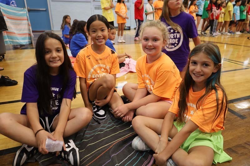 Students smiling in gymnasium.