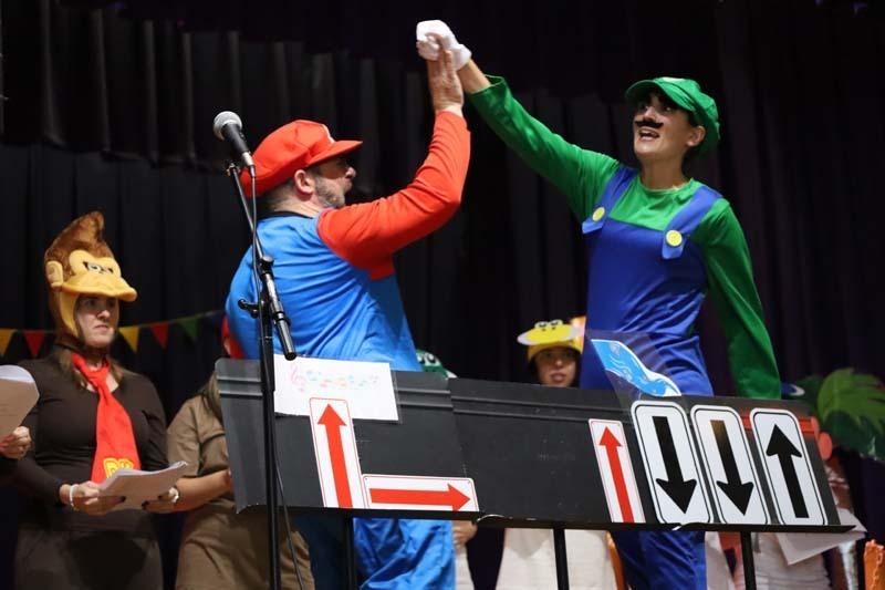Two men high fiving dresses as Mario and Luigi.