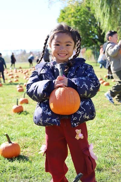 Student holding pumpkin.