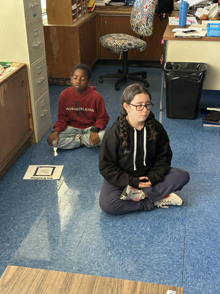 students in classroom on floor