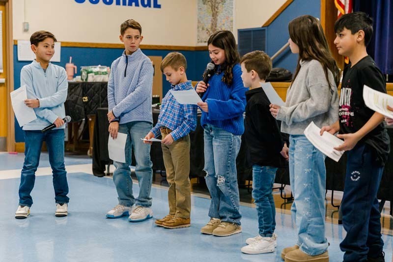 Students reading frmo paper.