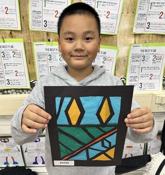 Student holding their artwork.