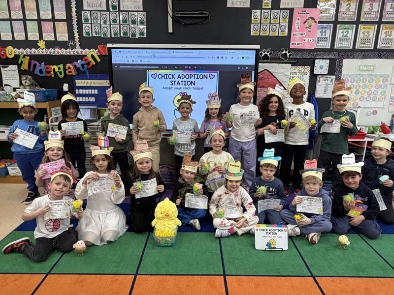 Students smiling, holding certificates.