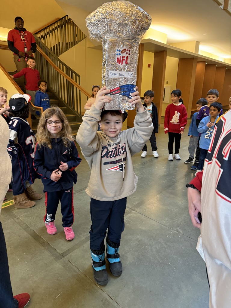 Student holding Lombardi trophy
