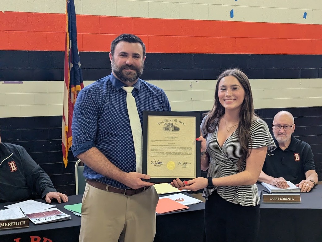 student poses with principal 