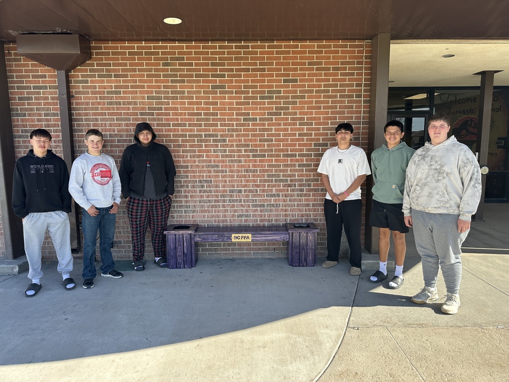 FFA students posing with the bench they made.