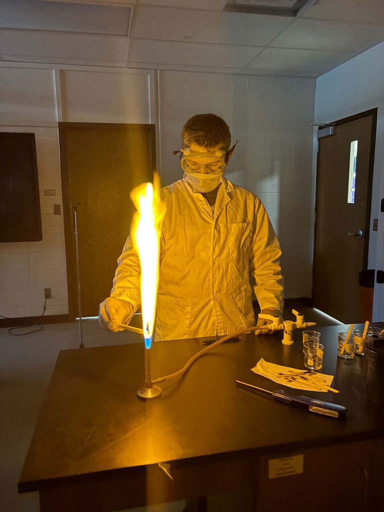 Student making yellow flame