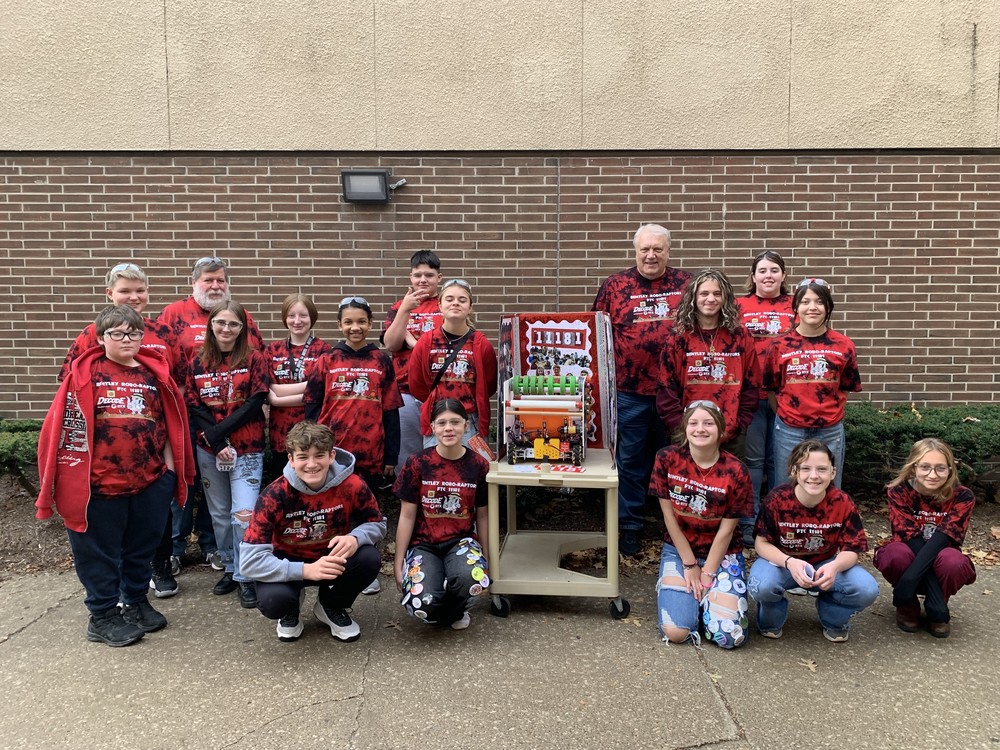 This image shows the BMS Robo-Raptors with their robot.