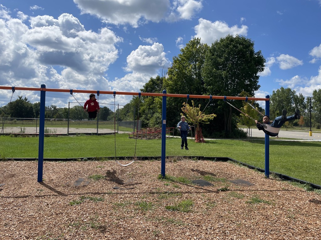 Students swinging on swings
