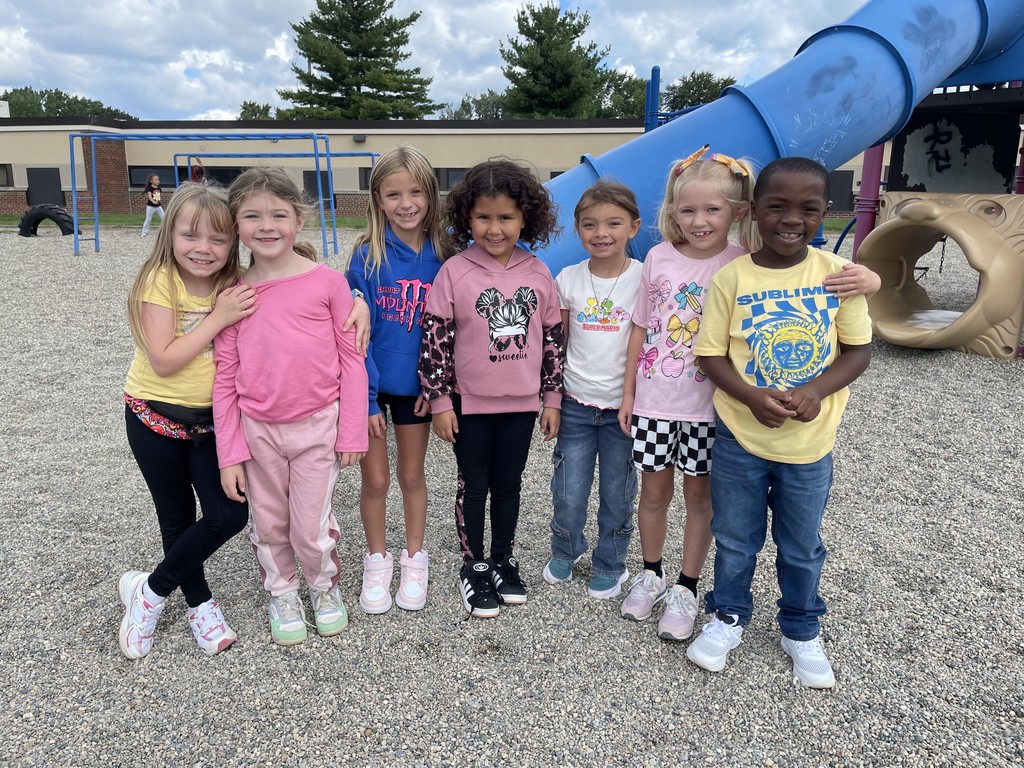 A group of students posing by the slide