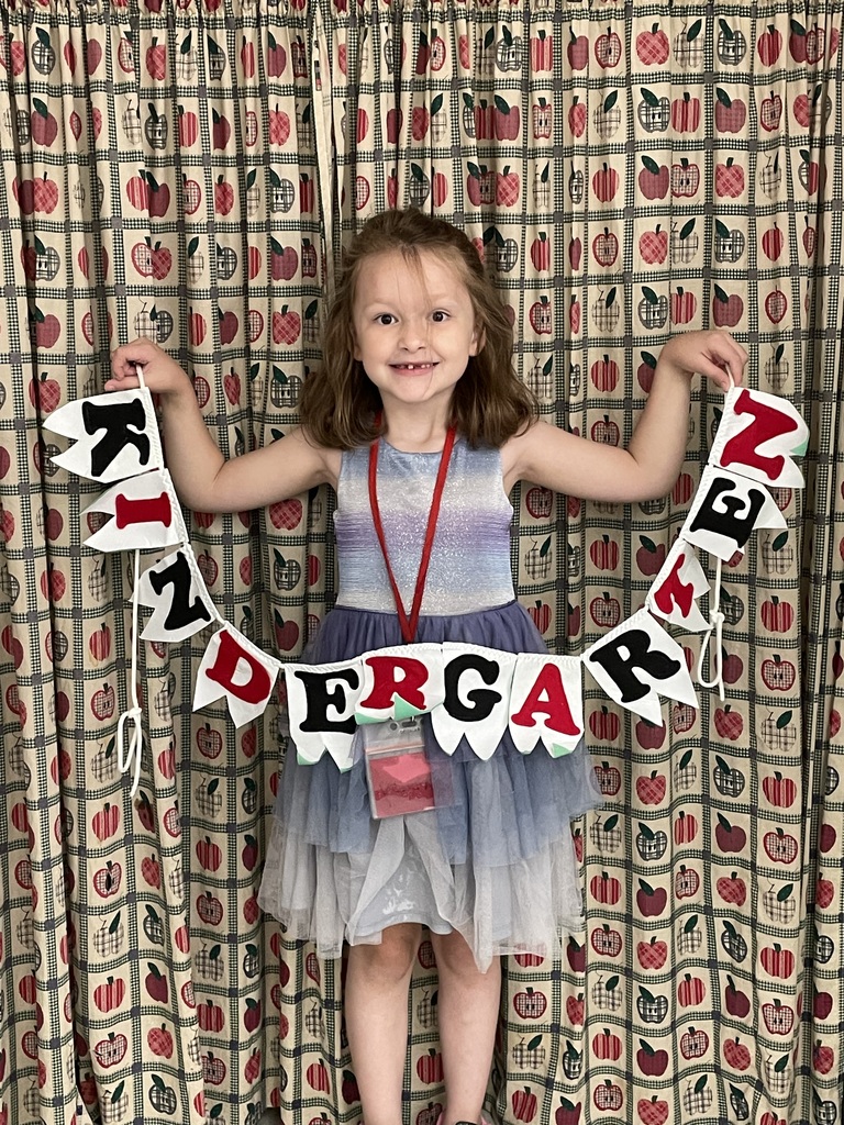 Girl posing with Kindergarten sign