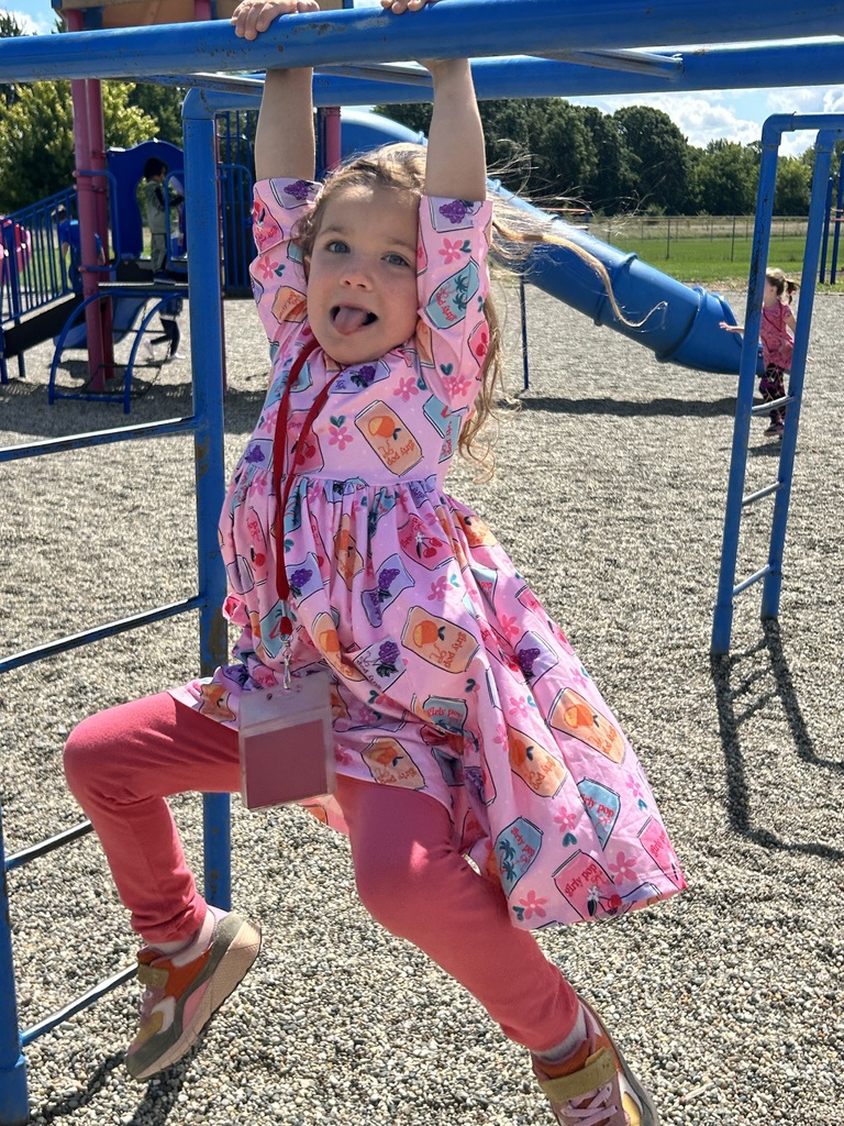 Girl hanging on playground structure