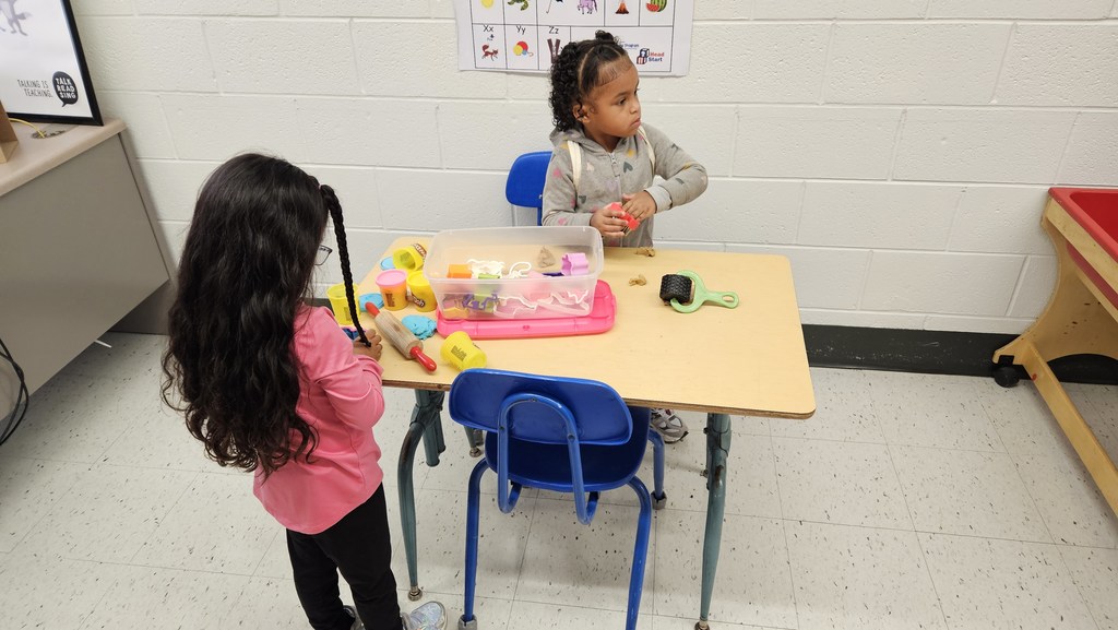 Two of our new little Bulldogs busy creating with Play Doh.