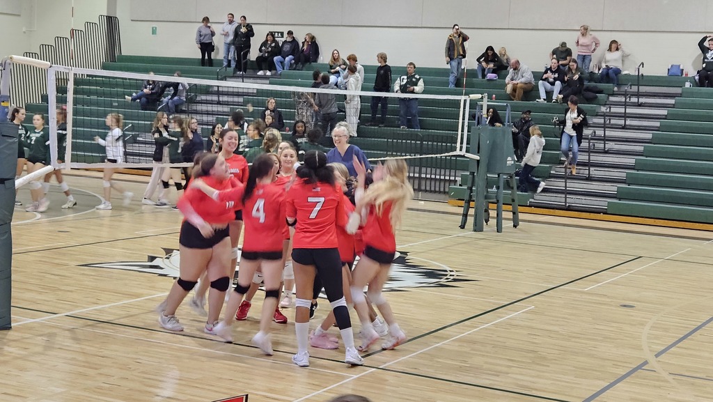 Image shows the Bentley girls gathered in a huddle after winning their third game.