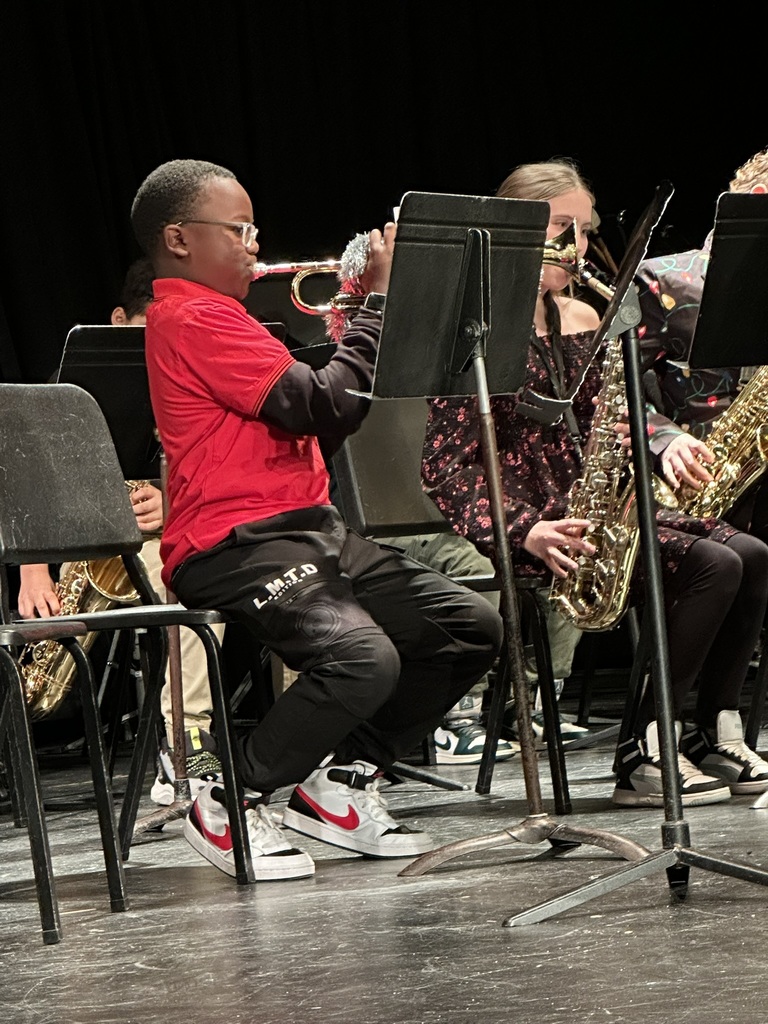 The image shows a student playing at the band concert.