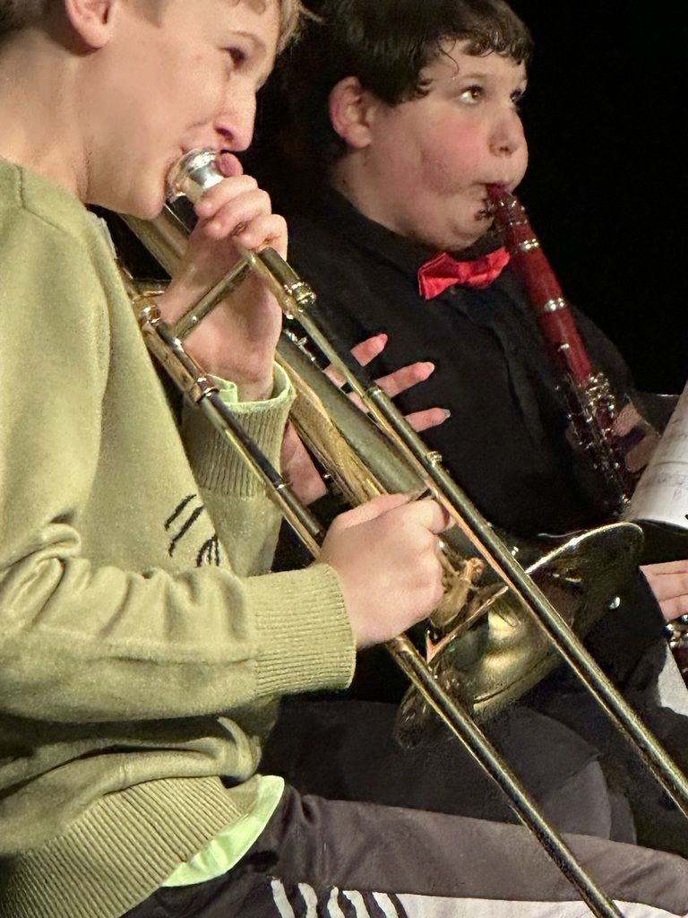 The image shows students playing at the band concert.