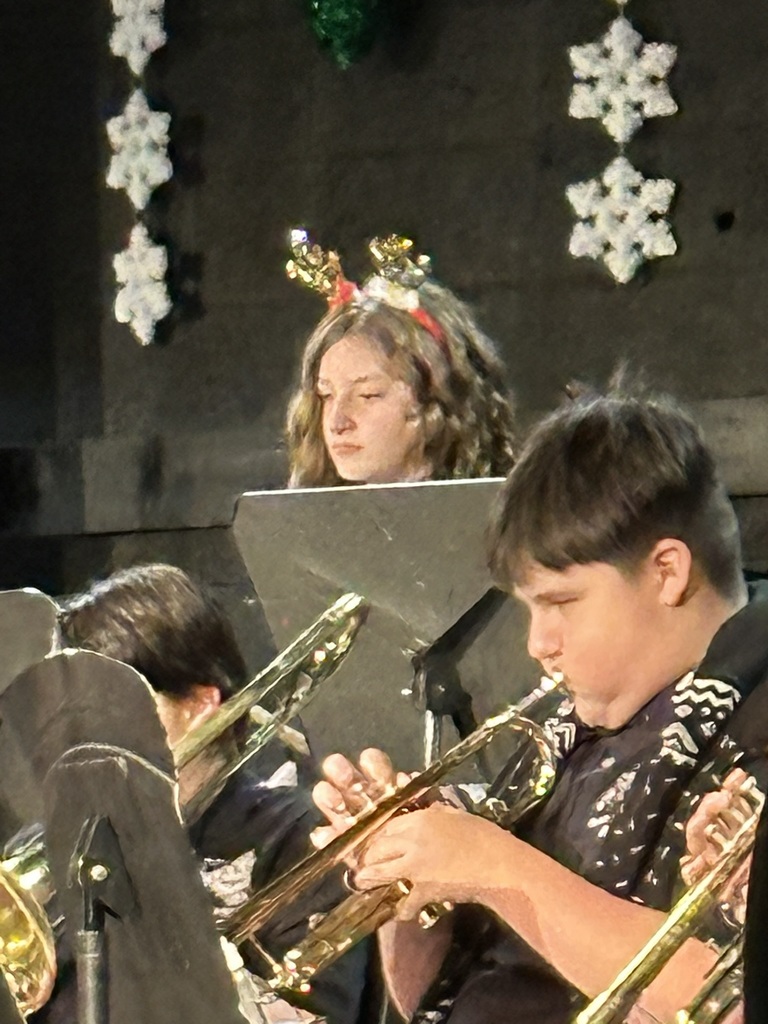 The image shows students playing at the band concert.