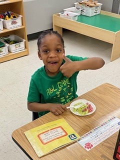 Kindergarten student enjoying St. Patrick's Day snack