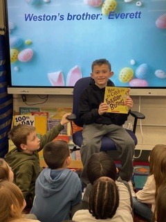 Student reading to Kindergarten