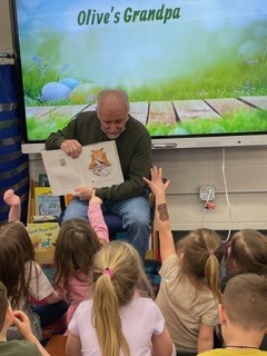 Grandfather reading to Kindergarten