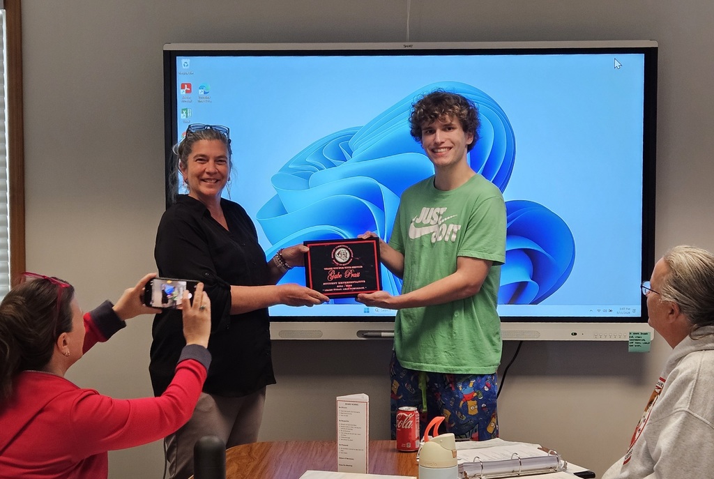 Picture of Student Rep Gabe Prast receiving award from Board president Amanda Mobley