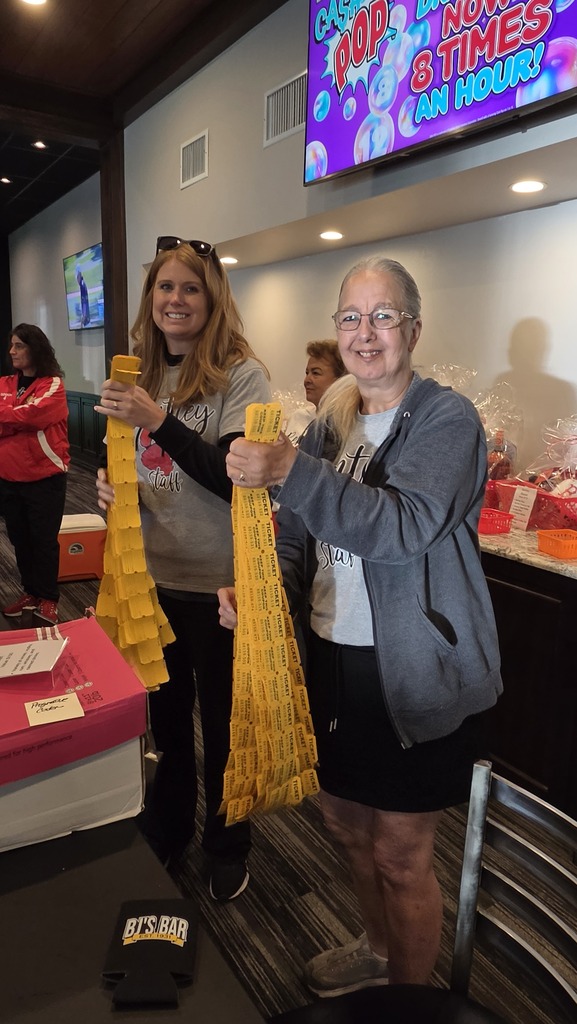 Image from the golf outing - volunteers preparing for the raffle