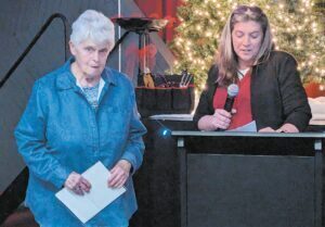 Toby Baldry, left, listens as Bentley Board of Education President Amanda Mobley talks about the former bus driver and board members 50 years of service to the school district. Photo by Gary Gould