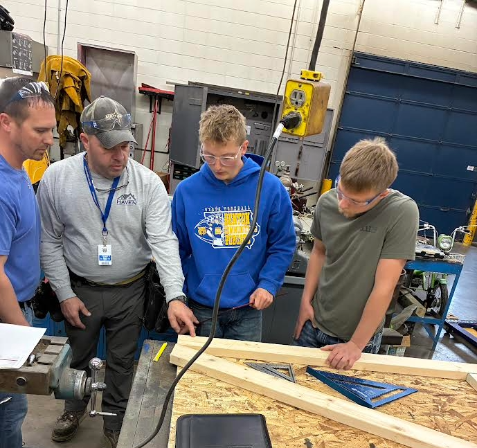Jeremy with Haven Enterprises helping students build trusses. 