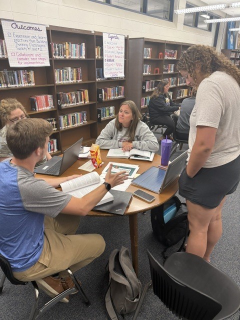 Teachers collaborating in Benton Library
