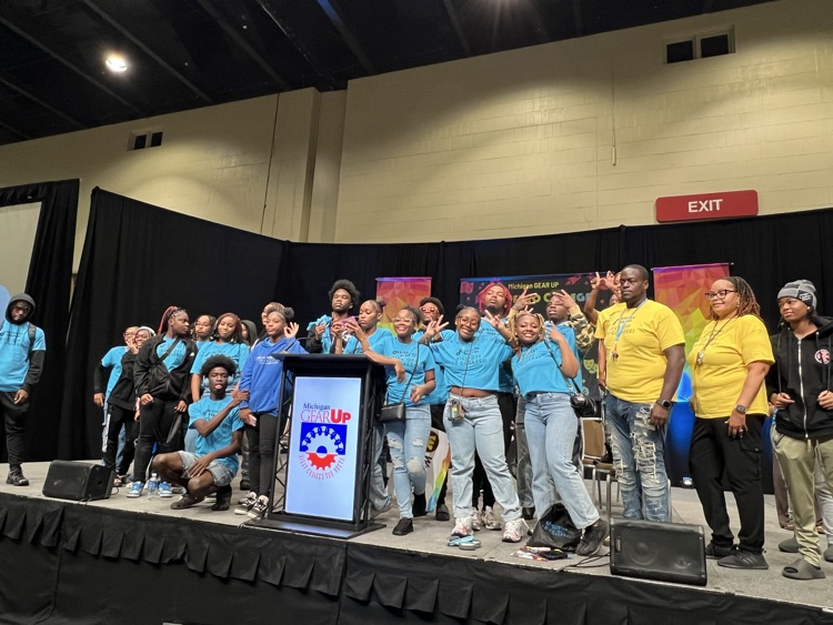 BHHS Students smiling in blue GearUp shirts on stage