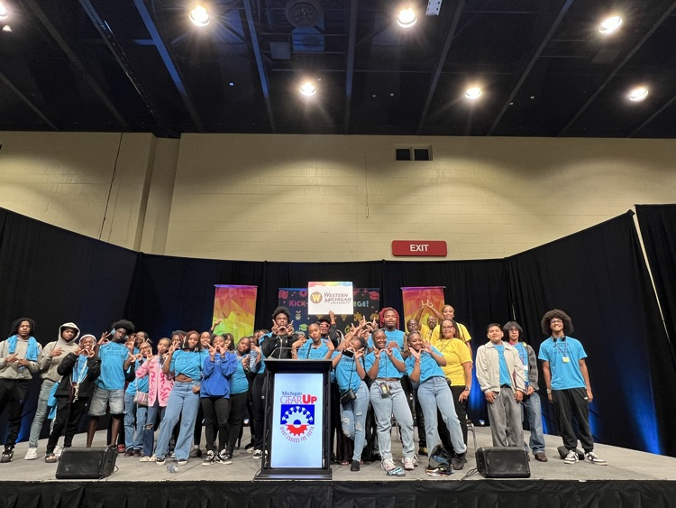 BHHS Students smiling in blue GearUp shirts on stage