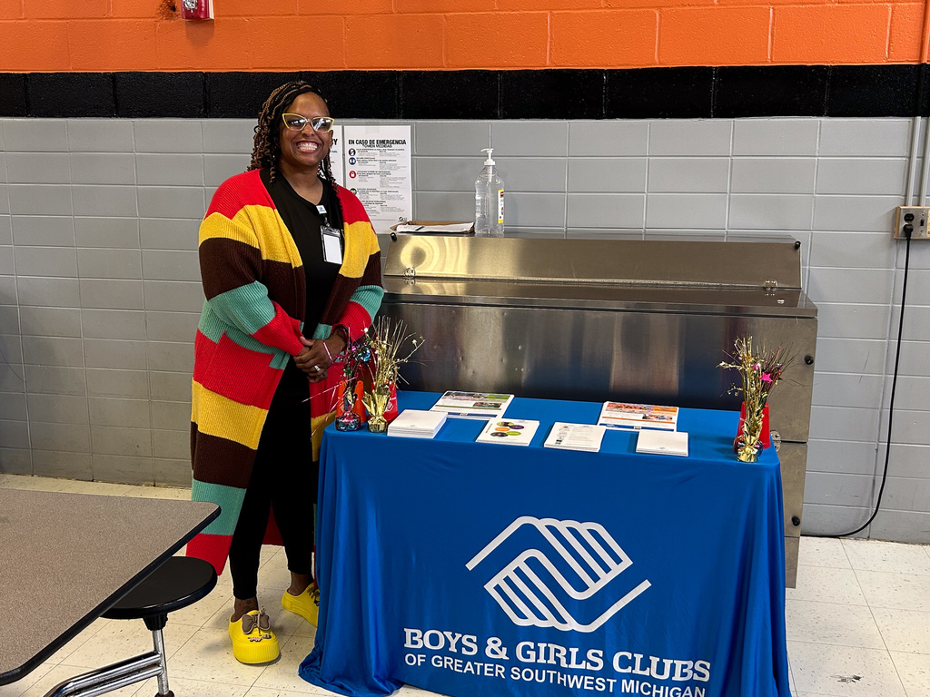 Woman smiling at Boys & Girls Club Resource Table