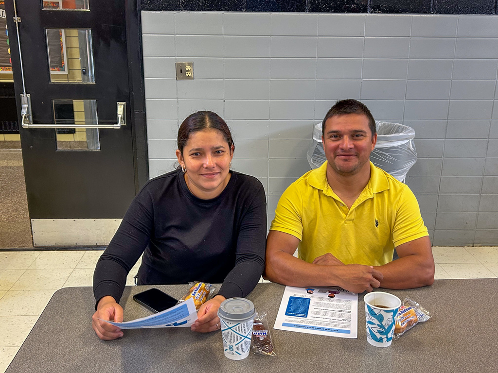 Parents sitting at table smiling