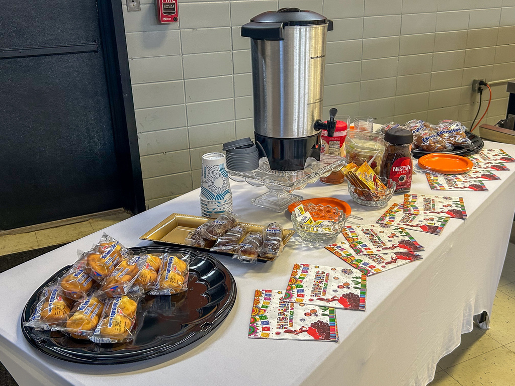 Table with pastries, coffee, and Hispanic heritage month napkins
