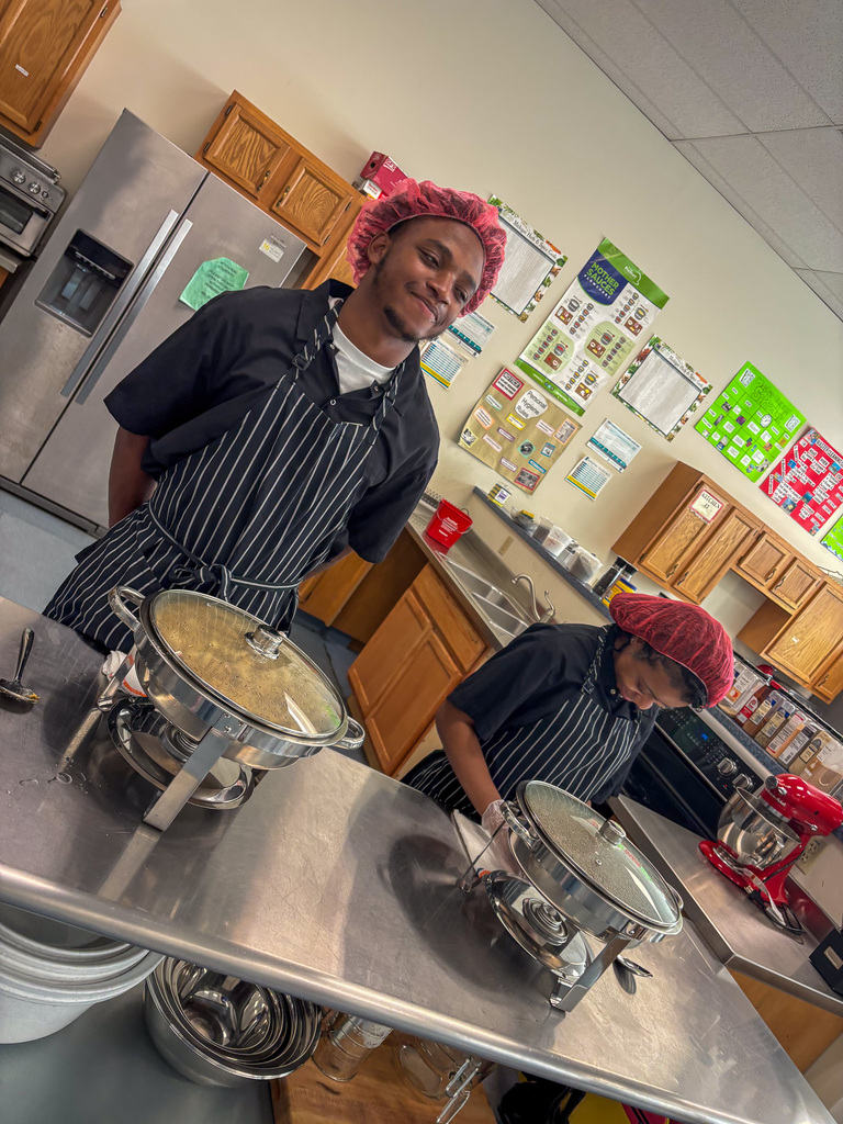 Staff getting lunch served by CTE Students